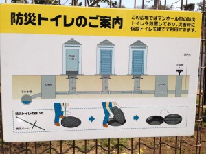 Instructions for pop-up toilets to handle crowds on the fence of a designated evacuation lot in a Tokyo neighborhood