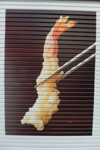 This advertisement for a local restaurant was on somebody's garage door.  Notice the shrimps "eye".....it is actually a key to the door.  We thought it was funny.